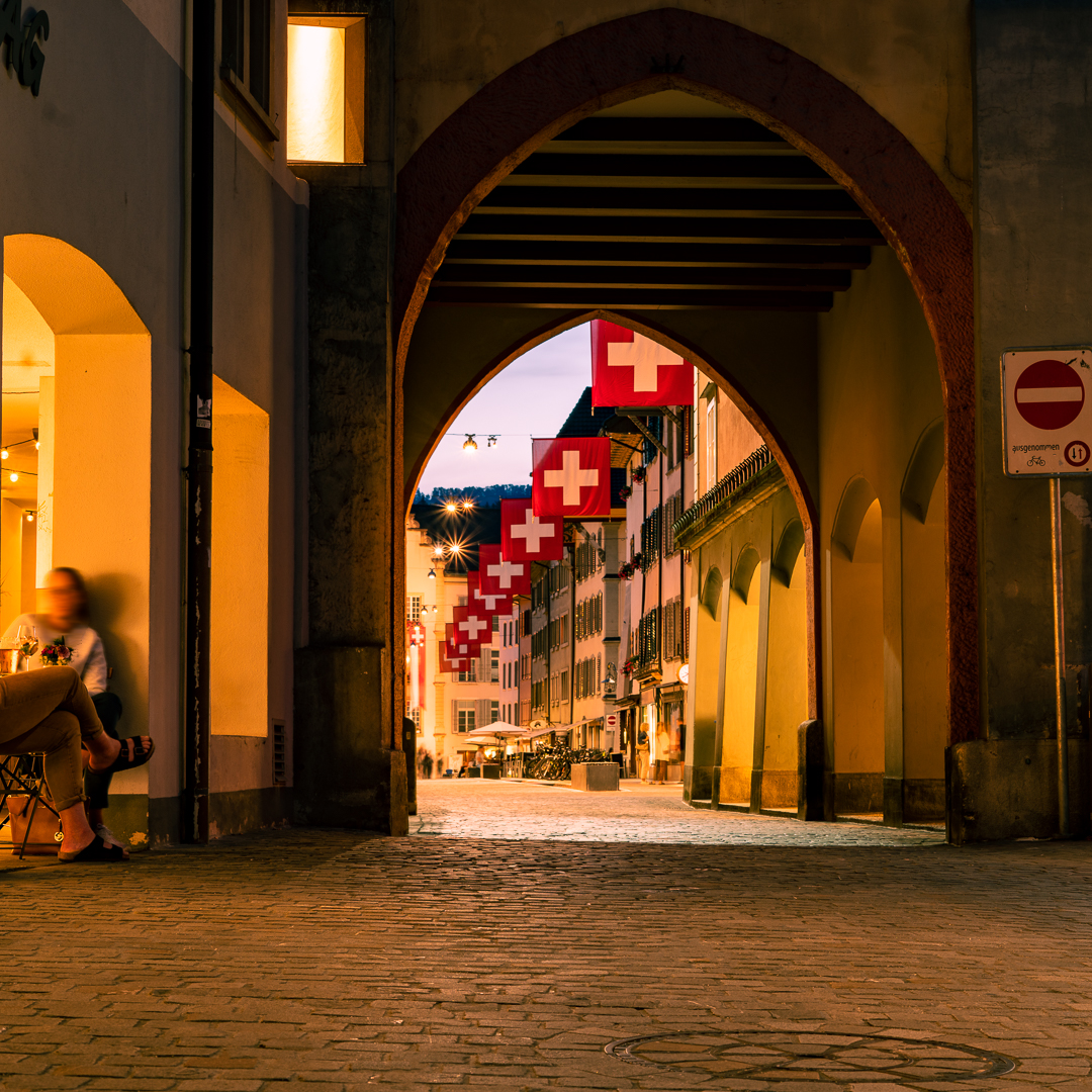 Swiss National Holiday - Decorated streets during the Swiss National Holiday in Aarau. People anticipate the coming event (with big fireworks) and stroll the streets of Aarau Downtown or have a drink sitting outside. 